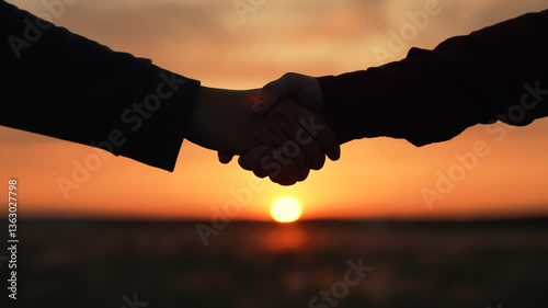 Handshake at sunset silhouette in park field. Powerful handshake people building long-term business relationships establishing trust fostering successful partnerships relations agricultural industry.