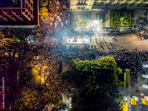Nighttime drone shots of Guatemala City during Holy Week celebrations. Aerial view of an illuminated procession surrounded by Catholic parishioners.