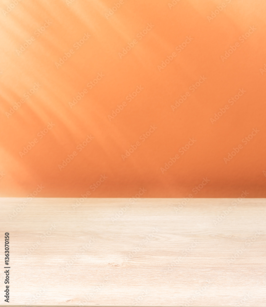 © volff - Blurred shadow of tropical palm leaves on the peach wall and table top in the foreground. Summer concept. © volff - Blurred shadow of tropical palm leaves on the peach wall and table top in the foreground. Summer concept.