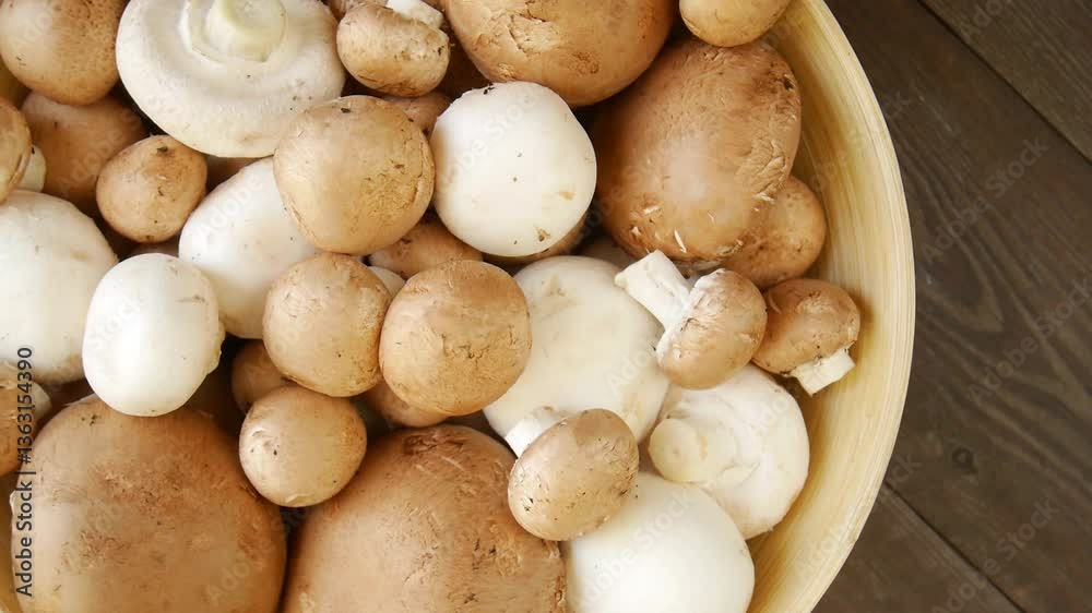 Champignon mushrooms in a wooden bowl. Champignon mushrooms in a wooden bowl.