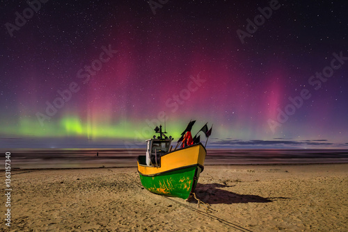 Fototapeta Naklejka Na Ścianę i Meble -  Northern lights over the Baltic Sea beach in Jantar with fishing boats, Poland.
