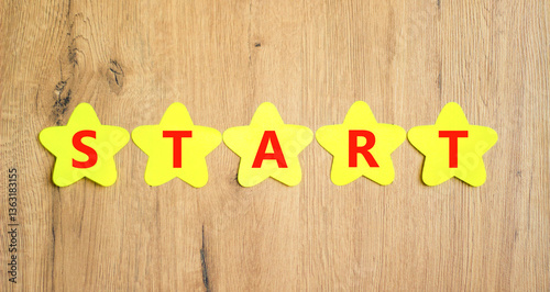 Wallpaper Mural Start symbol. Concept word Start on beautiful yellow paper stars. Beautiful wooden table wooden background. Business lifestyle start concept. Copy space. Torontodigital.ca