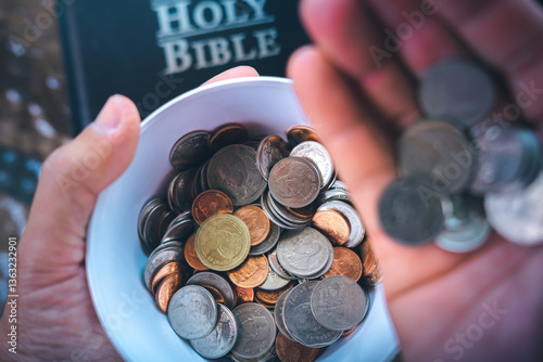 Coins with Holy Bible, a closeup, Christian biblical concept of tithing, Biblical concept of Christian offering