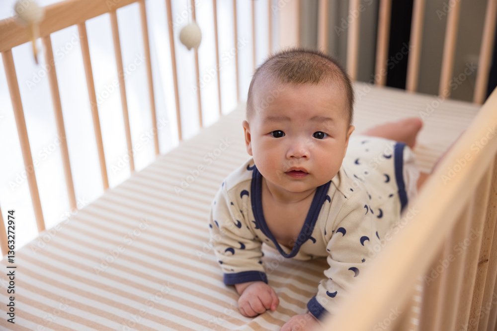 Little baby crawling in wooden crib carefully Little baby crawling in wooden crib carefully
