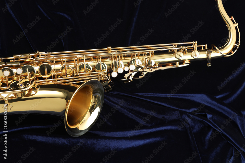 Obraz premium Jazz. One beautiful saxophone on dark blue fabric
