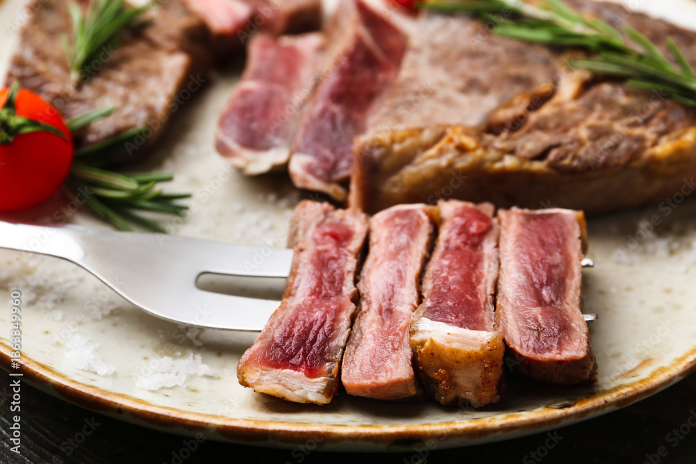 Pieces of delicious beef meat, spices and tomato on table, closeup Pieces of delicious beef meat, spices and tomato on table, closeup