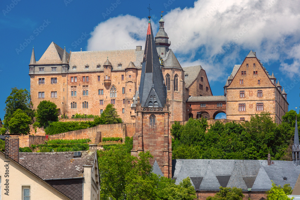 Landgrafenschloss castle on hill above traditional fachwerk houses in Marburg Germany on a sunny summer day