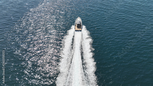 Obraz na płótnie Aerial drone photo of luxury rigid inflatable speed boat cruising in high speed in Aegean deep blue sea, Greece w salonie
