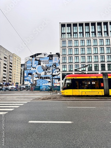 view of a tram on a Warsaw street with buildings in the background on a cloudy winter day
