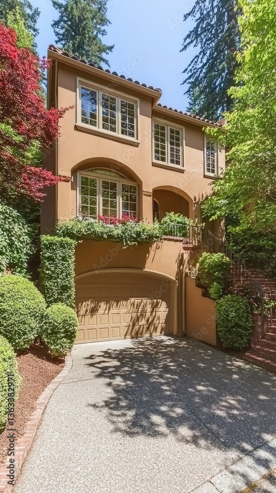 Fototapeta premium Home with terracotta walls, flowers. Surrounded by greenery. Driveway. For real estate ad