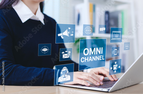 OmniChannel marketing concept. Businesswoman using laptop with digital icons represent omni channel marketing. email, e-commerce, social media, analytics, customer engagement, multichannel market,