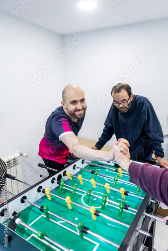 Friendly foosball game promotes bonding in mental health residence