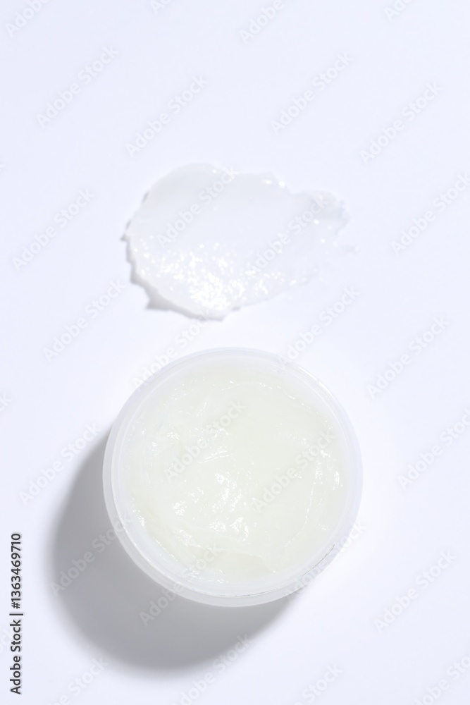 Moisturizing lip balm and jar on white background, top view Moisturizing lip balm and jar on white background, top view