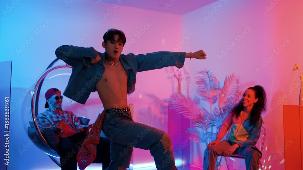 Skilled asian dancer moving to modern music while multicultural friend sitting at chair. Professional performer dancing show energetic foot step while hipster team cheering and supporting. Regalement.