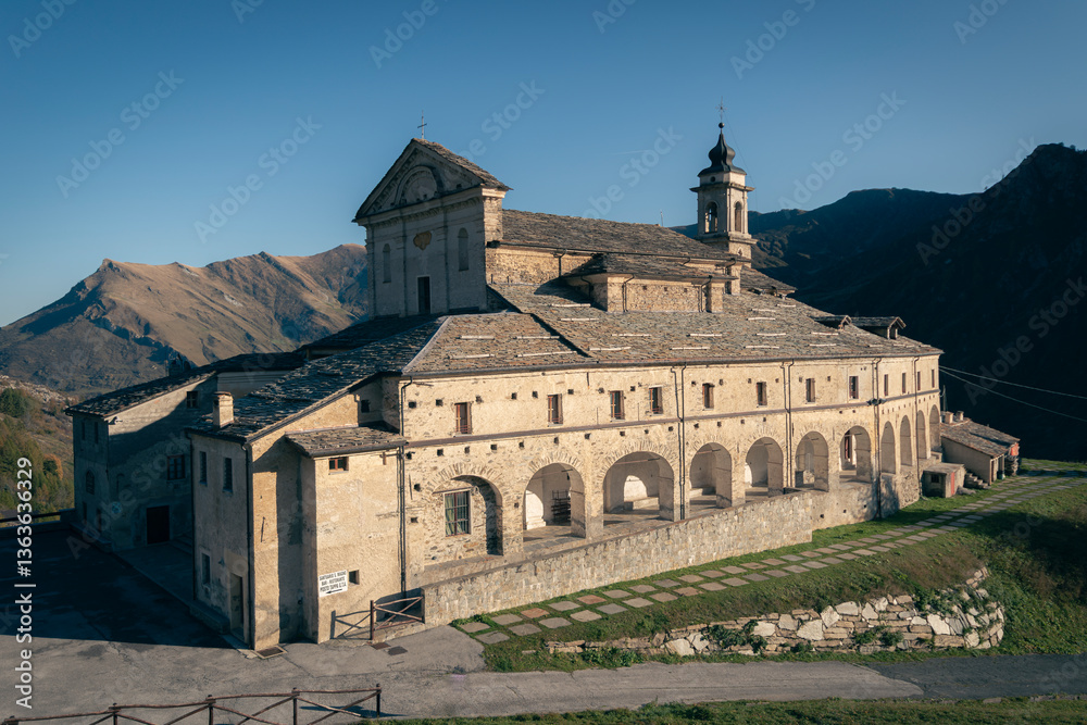 Fototapeta premium Saint Magnus Sanctuary, at the top of the Grana Valley, in the Alps of Cuneo, Piedmont, Italy. Homeland of the king of cheeses, the Castelmagno.