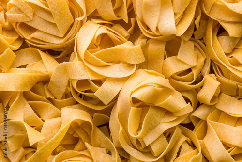 Photos Italian pasta tagliatelle. Uncooked noodle pasta
