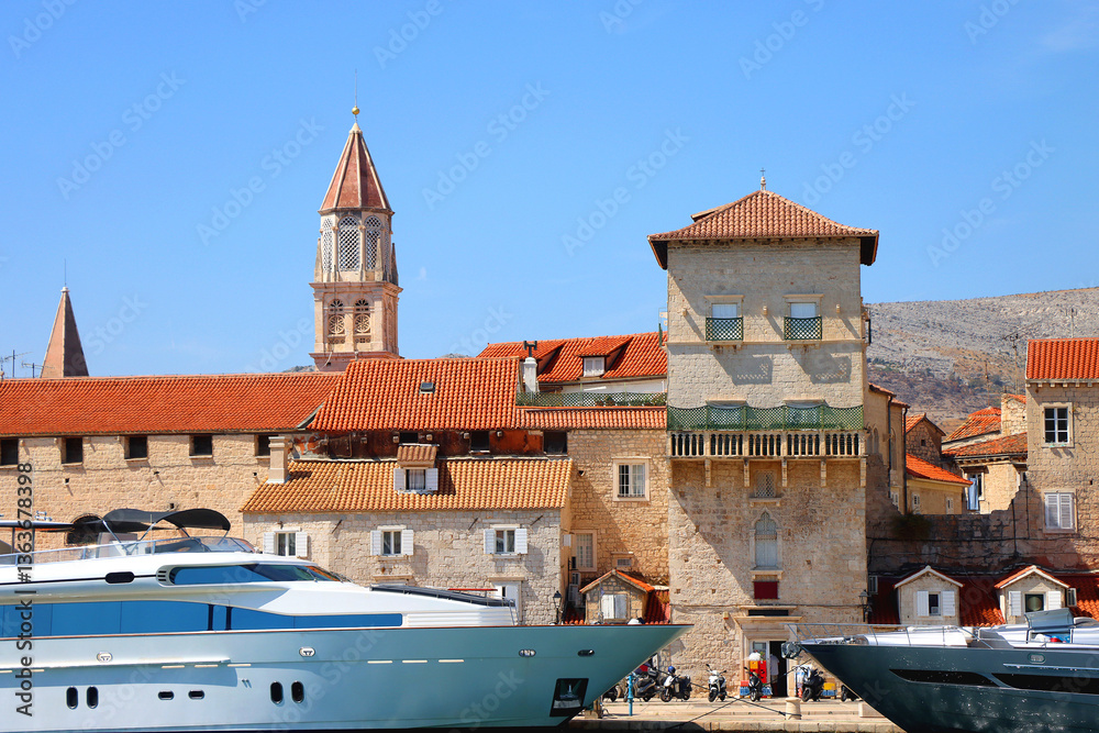 Beautiful old buildings, boats and yachts on the promenade in Trogir, Croatia. Sunny summer day in Trogir.