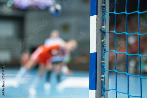 Obraz na płótnie Detail of goalkeeper's hand and handball game in the background. w salonie