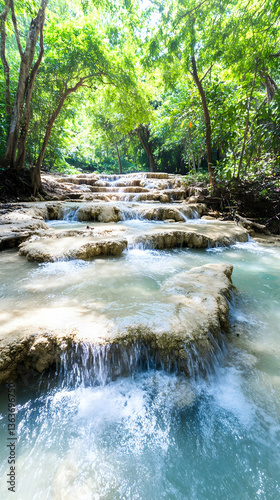 Serene cascading waterfall in lush green jungle