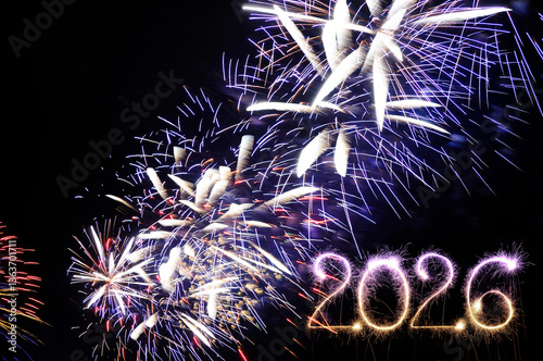 Sparkler 2026. Firework illumination on dark sky background, happy new year 2026 concept. Sparkler 2026 text colorful firework. Happy New Year 2026 firework overlay background. Sparks, fireworks