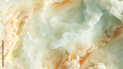 A close-up view of a beautiful onyx stone surface, showcasing its intricate patterns and colors. The stone features soft hues of cream, peach, and light green, creating a serene and elegant.