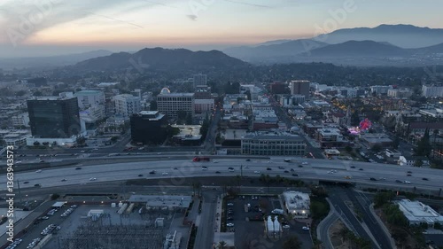 Riverside, California, USA - December 31, 204: A train pulls into the Downtown Train Station and traffic passes on the 91 freeway. photo
