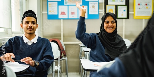 Classroom scene with Muslim students in uniforms. A Muslim girl student raises her hand, smiling. Muslim students engaged in learning. Educational environment, active participation. photo