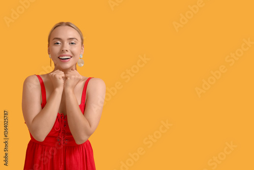 Happy young woman on orange...