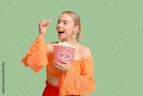 Happy young woman eating po...