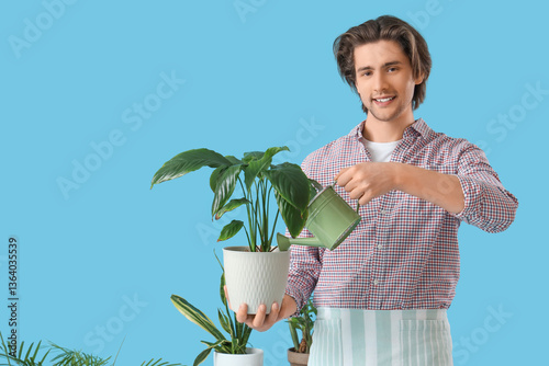 Handsome gardener watering ...