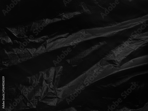 Black background plastic wrinkle bag film glossy crumpled overlay package rough wrap material pack reflection texture floor packaging retail grain pollution trash polyethylene, halloween backdrop.