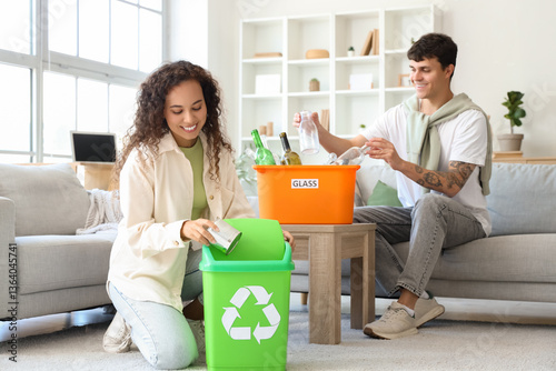 Young couple with garbage c...