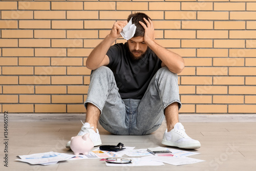 Stressed young man in debt ...