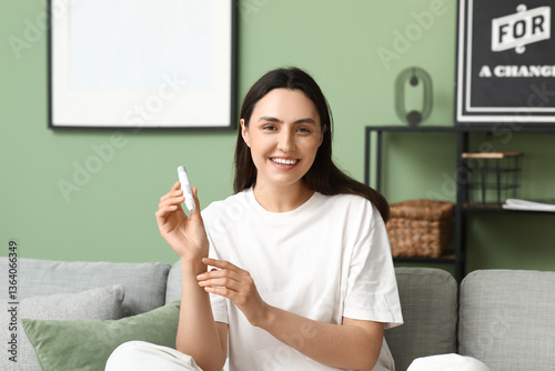 Smiling young woman holding...