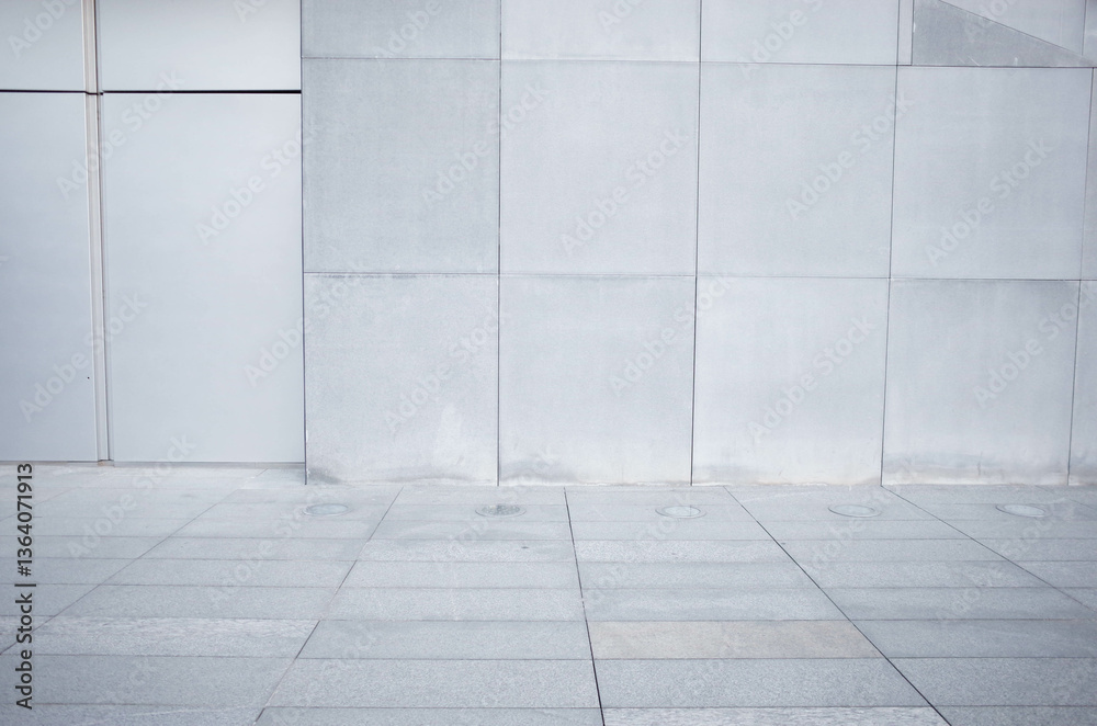 a fragment of a street city concrete wall of a building and an paving stones. Building's facade.