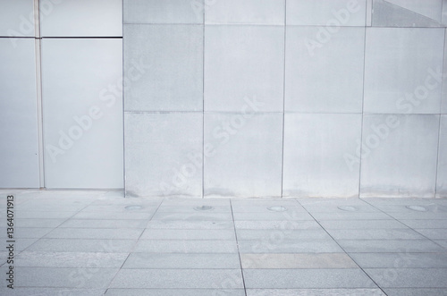 Obraz na płótnie a fragment of a street city concrete wall of a building and an paving stones. Building's facade. w salonie