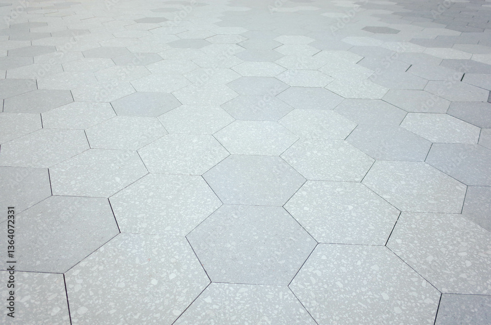 Grey brick stone street road. Light sidewalk, pavement texture. Granite hexagon. outdoor tiled floor.