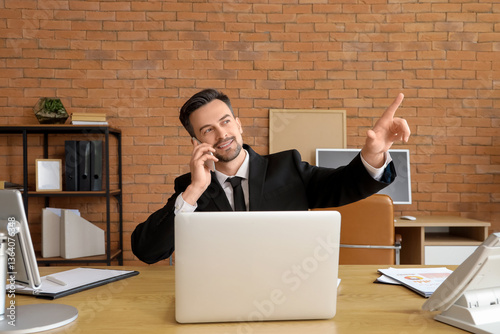 Young businessman with mobi...