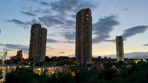 Wallpaper Mural A breathtaking view of a city skyline featuring modern illuminated towers against a colorful dusk sky. Torontodigital.ca
