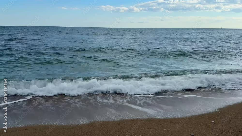 This is a serene beach scene beautifully showcasing gentle waves combined with a clear, radiant blue sky This is a serene beach scene beautifully showcasing gentle waves combined with a clear, radiant blue sky