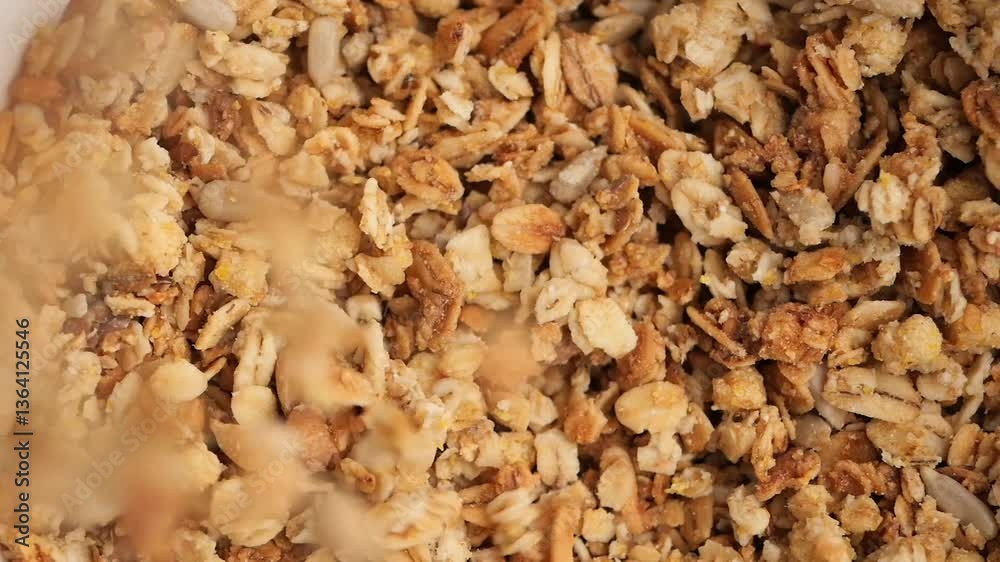 milk pouring in Crunchy granola with nuts and seeds made at home milk pouring in Crunchy granola with nuts and seeds made at home