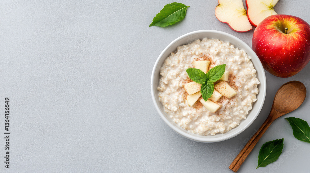 Creamy oatmeal topped with fresh apple, cinnamon, and mint leaves, perfect for cozy breakfast Creamy oatmeal topped with fresh apple, cinnamon, and mint leaves, perfect for cozy breakfast