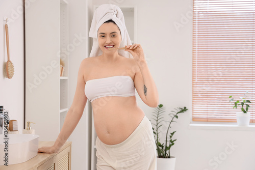 Pregnant woman brushing tee...