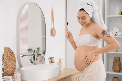 Pregnant woman brushing tee...