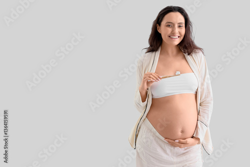 Pregnant woman brushing tee...