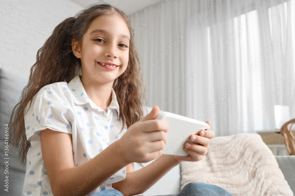 Cute girl using mobile phone on sofa at home Cute girl using mobile phone on sofa at home