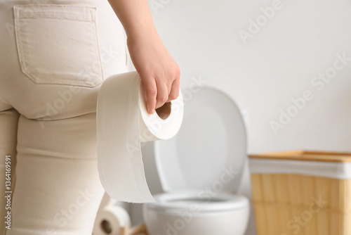 Young woman with toilet pap...