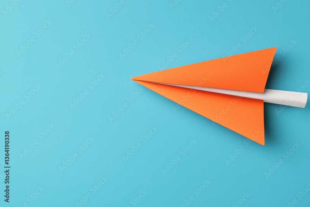 Fototapeta premium Vibrant Orange Paper Airplane Gliding Against a Bright Blue Background Symbolizing Freedom And Creativity