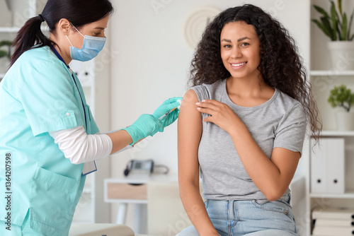 Female doctor vaccinating A...