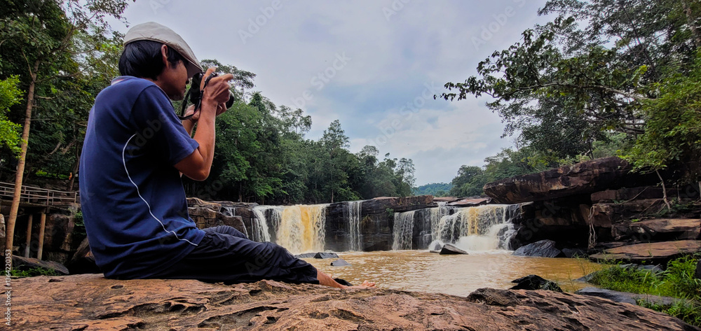 Photographer with waterfall